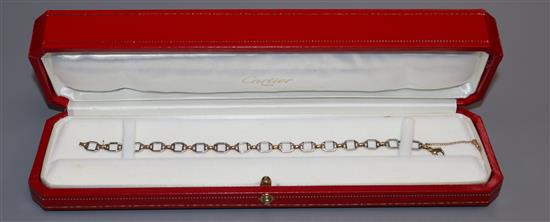 A Cartier steel and yellow metal bracelet with box and certificate, (later replaced 9ct clasp), approx. 18cm.